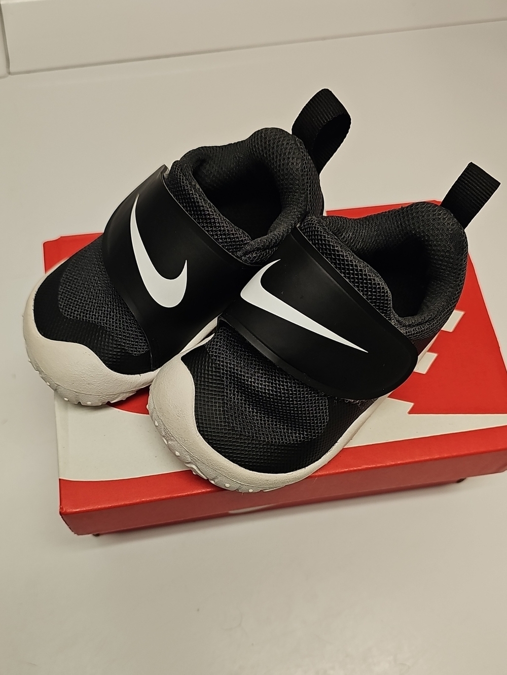 Nike Toddler Black and White Slip-On Sneakers